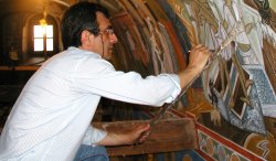 Markos Kampanis painting a mural